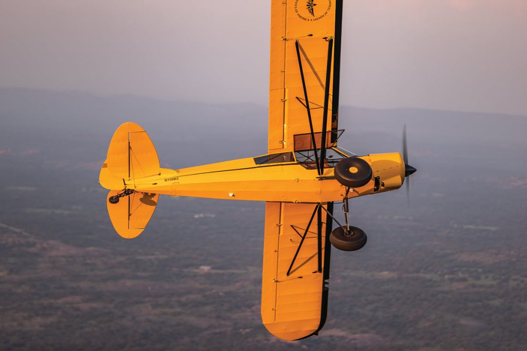 belly of Piper Super Cub in flight